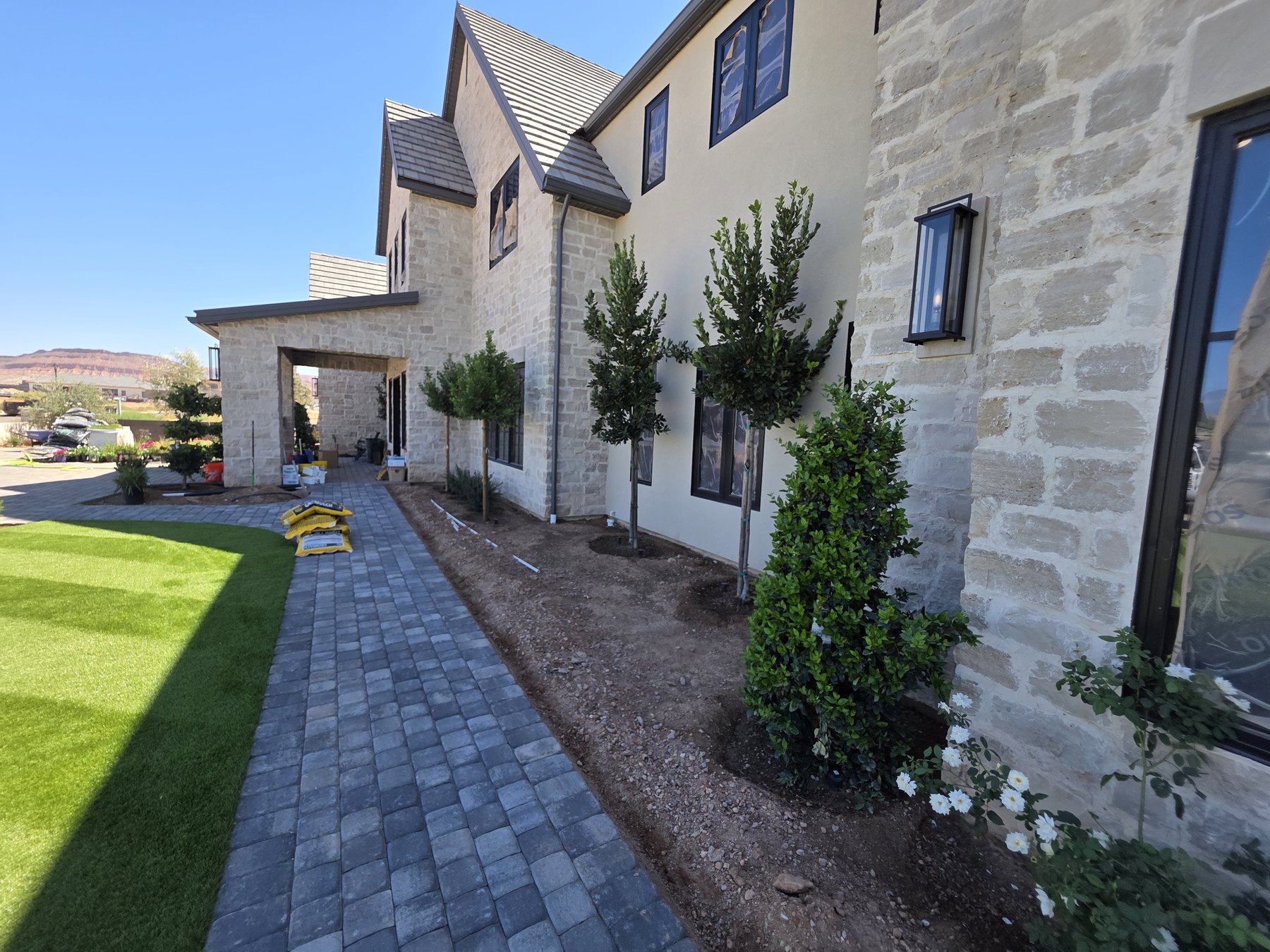 Stone paver walkway and landscaped garden beds